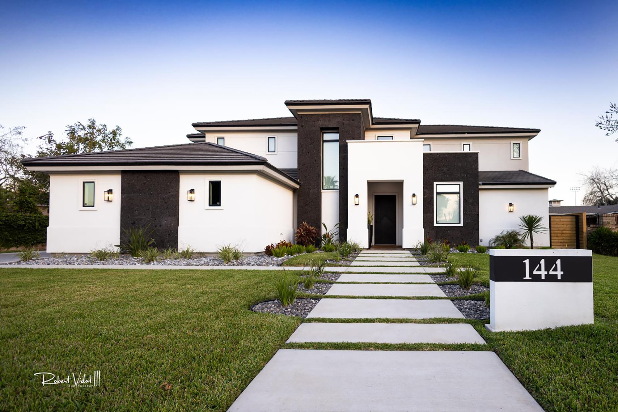 Completed Vanegar House by HCD Group, with a landscaped front garden and entry walkway.